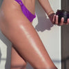 Applying THE SUPER SCRUB to upper leg and buttocks. Spreading the scrub into the leg